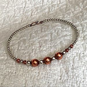 Two-tone rose gold and silver colored bracelet.